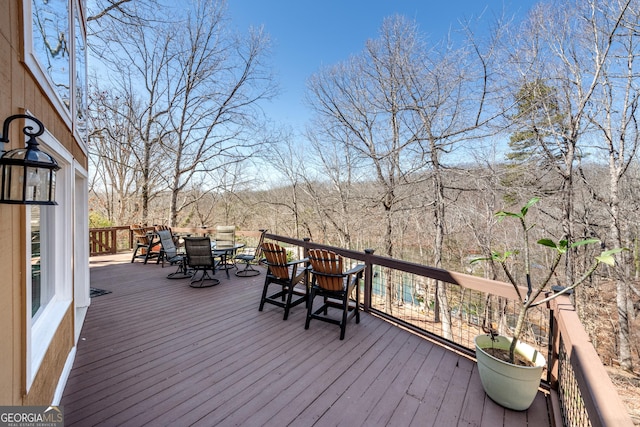 wooden deck featuring outdoor dining area