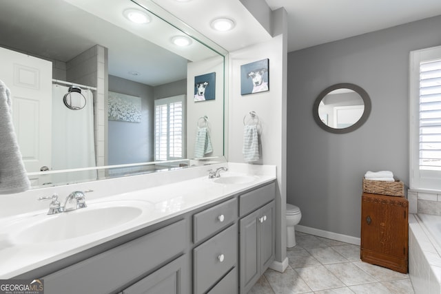 full bath featuring a sink, toilet, a bathtub, and tile patterned flooring