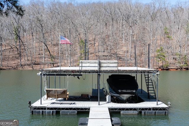 view of dock with a view of trees and a water view