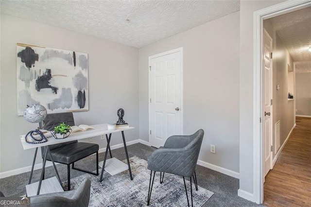home office with a textured ceiling and baseboards