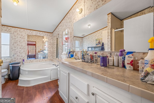 bathroom featuring wood finished floors, wallpapered walls, lofted ceiling, ornamental molding, and a bath