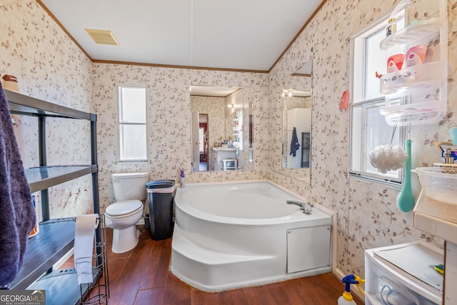 bathroom featuring visible vents, hardwood / wood-style flooring, ornamental molding, and wallpapered walls