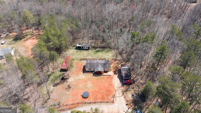 birds eye view of property with a wooded view