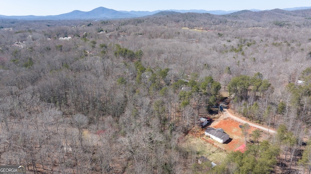 drone / aerial view with a mountain view and a forest view