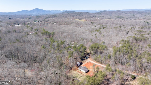 drone / aerial view with a forest view and a mountain view