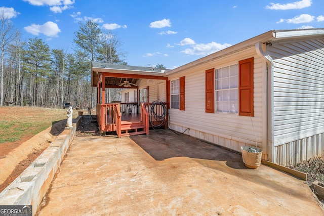 view of side of property with a deck and a patio