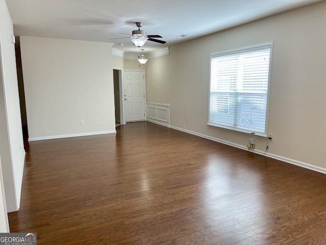 empty room with visible vents, baseboards, dark wood-type flooring, and a ceiling fan