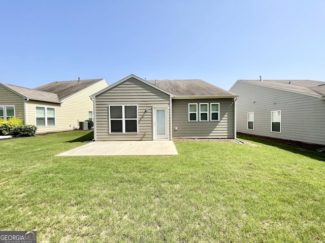 rear view of house with a patio area, a lawn, and central AC