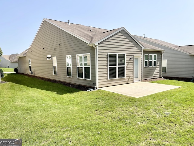 rear view of house featuring a patio area and a yard