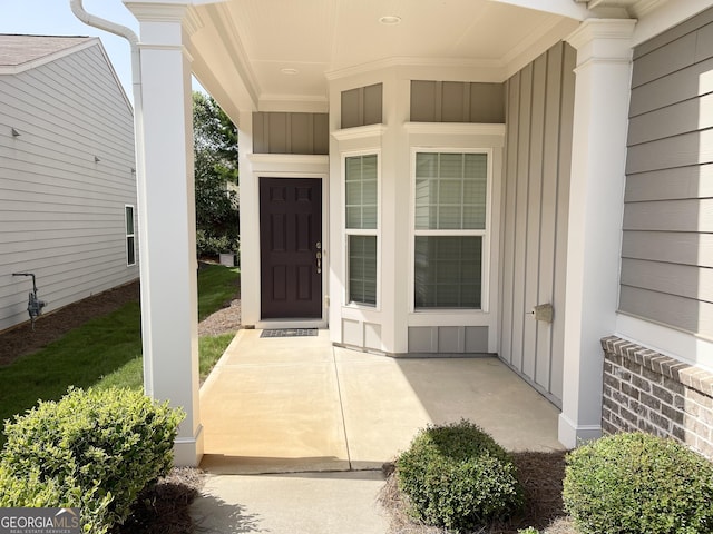 property entrance featuring board and batten siding