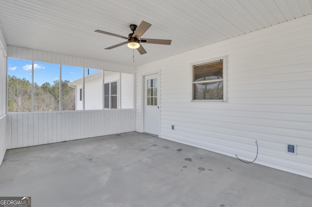 unfurnished sunroom featuring a ceiling fan