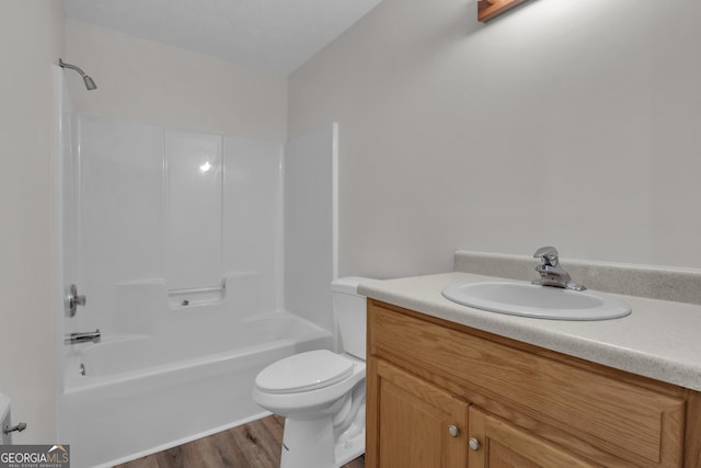 bathroom with toilet, vanity, shower / bathing tub combination, and wood finished floors