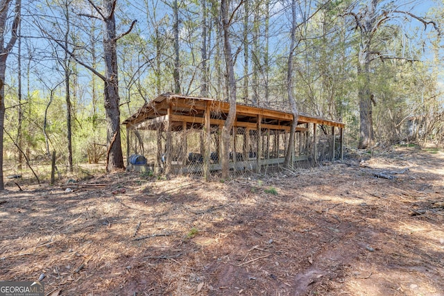 view of outbuilding with a view of trees