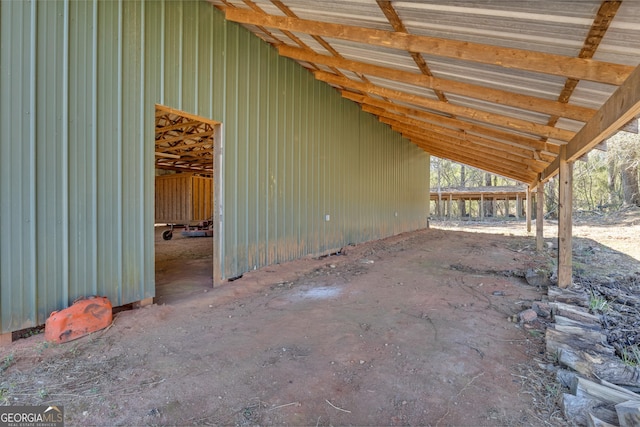 view of patio featuring a pole building, a carport, and an outdoor structure