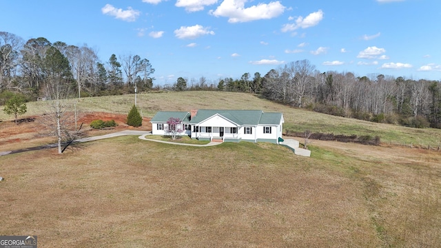 exterior space with a front lawn, covered porch, and driveway