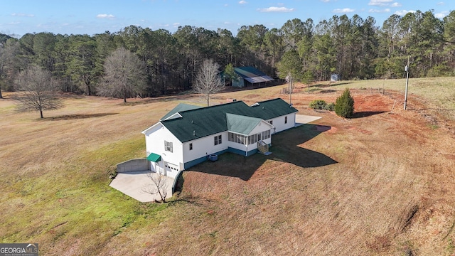 drone / aerial view featuring a view of trees