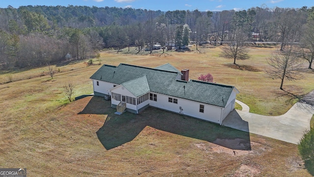 drone / aerial view with a wooded view