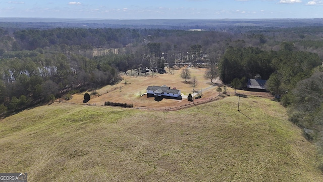 drone / aerial view featuring a rural view and a wooded view