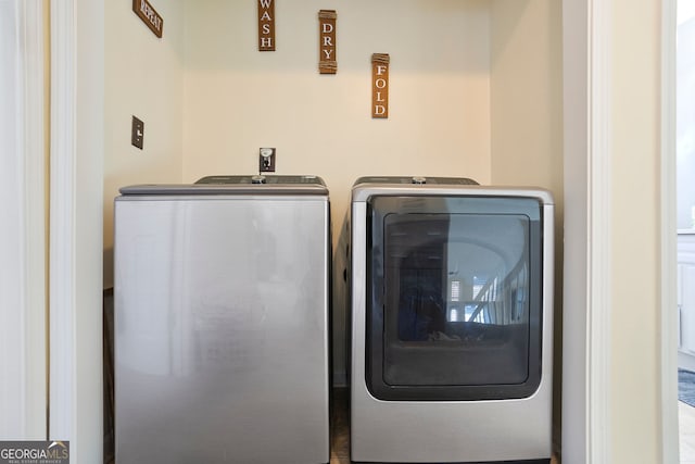 washroom featuring separate washer and dryer and laundry area