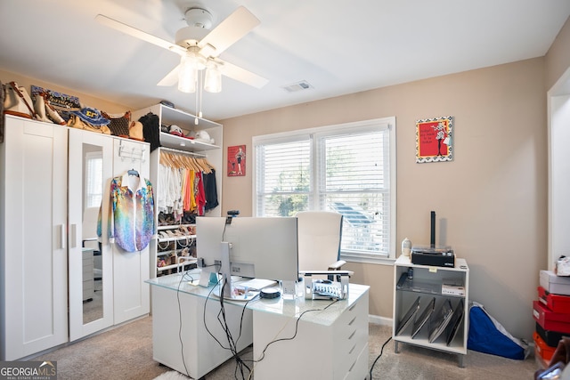 home office with visible vents, light carpet, and ceiling fan