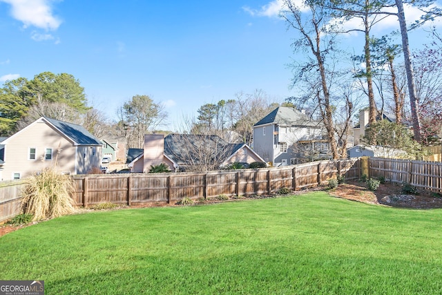 view of yard with a residential view and a fenced backyard