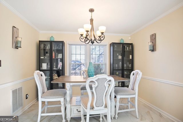 dining room featuring visible vents, baseboards, an inviting chandelier, and ornamental molding