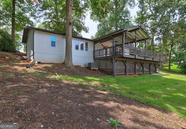 rear view of house featuring central AC unit, a yard, and a deck