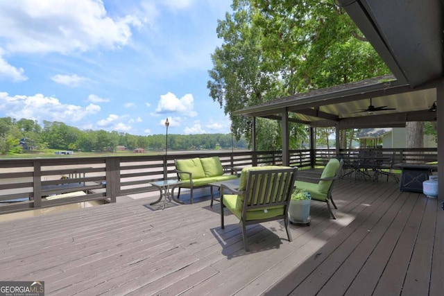 wooden terrace featuring an outdoor living space and a ceiling fan