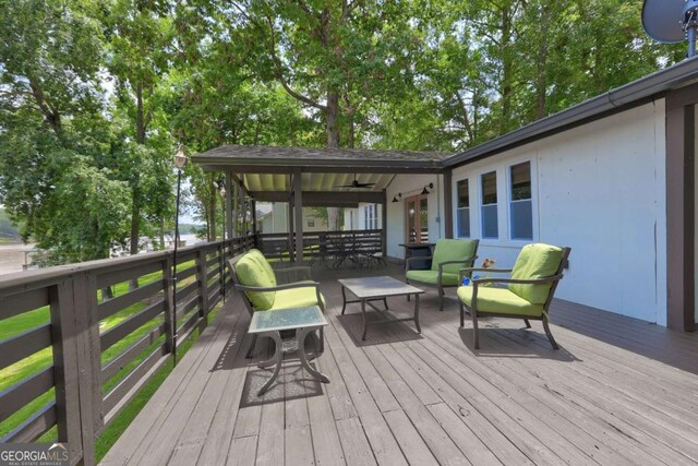 deck with ceiling fan, french doors, and outdoor dining space