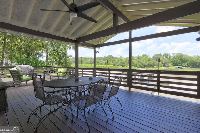 wooden deck with outdoor dining area and a ceiling fan