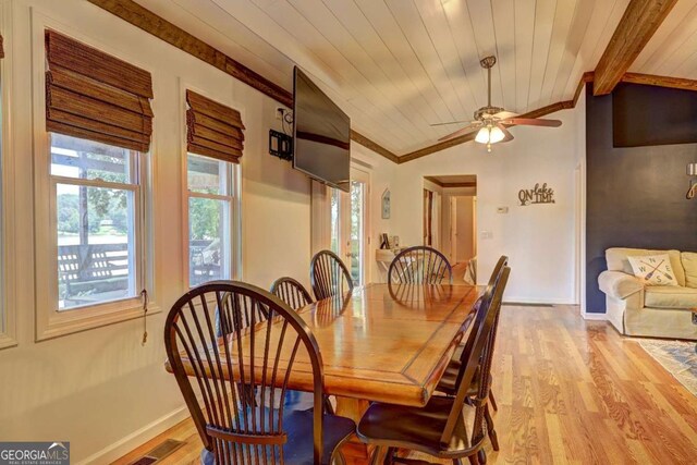 dining room featuring light wood-style floors, ornamental molding, baseboards, and a wealth of natural light