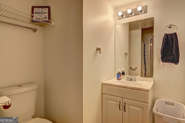 bathroom featuring toilet and vanity
