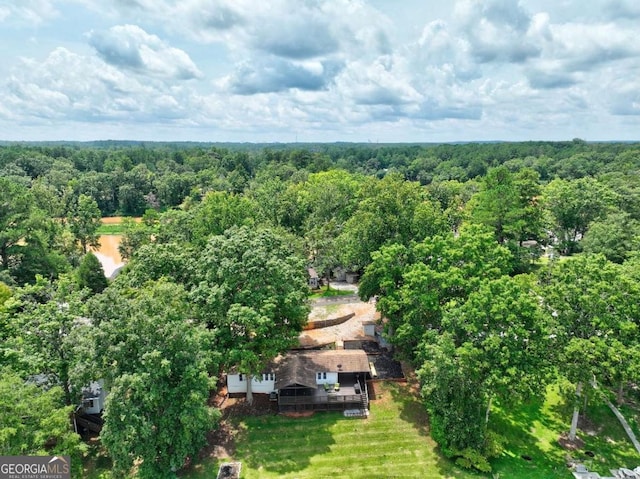 birds eye view of property with a wooded view