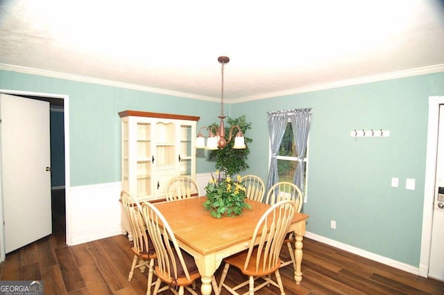 dining room with ornamental molding, baseboards, and wood finished floors