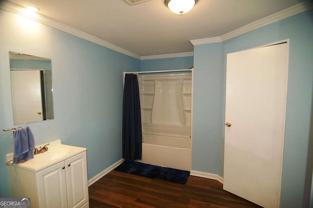 bathroom featuring crown molding, baseboards, shower / bath combo, wood finished floors, and vanity