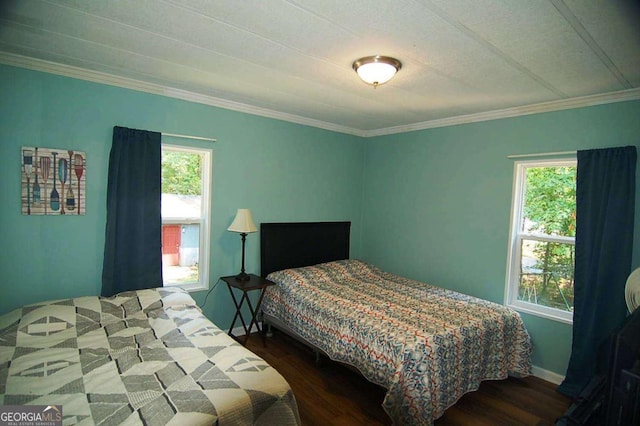 bedroom with multiple windows and wood finished floors