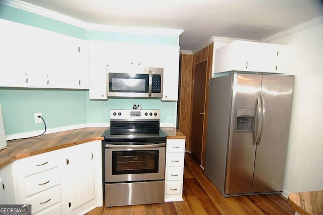 kitchen featuring crown molding, white cabinets, wood finished floors, and appliances with stainless steel finishes