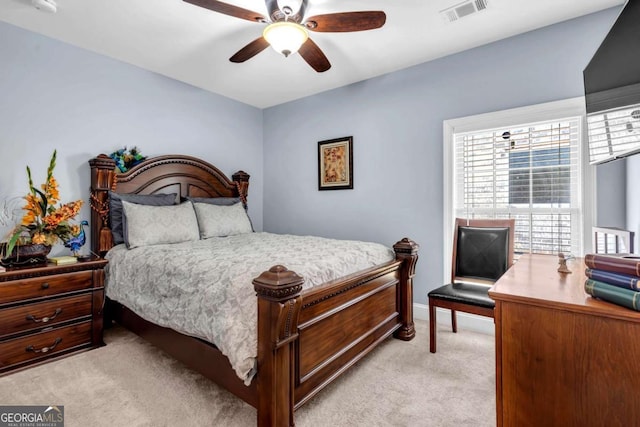 bedroom featuring ceiling fan, baseboards, visible vents, and light carpet