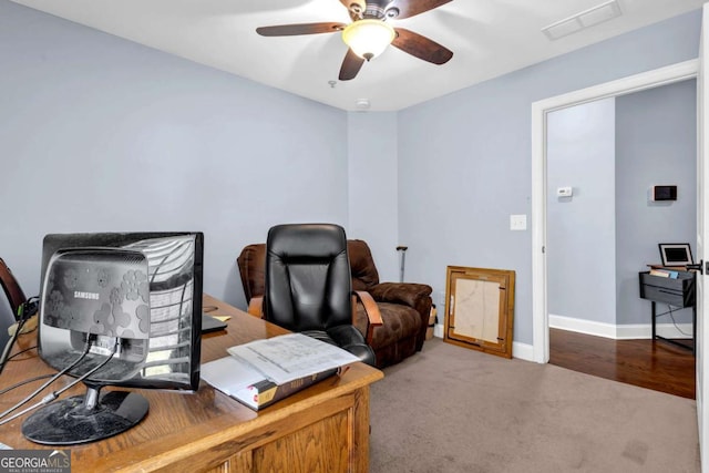 home office featuring visible vents, baseboards, carpet, and a ceiling fan