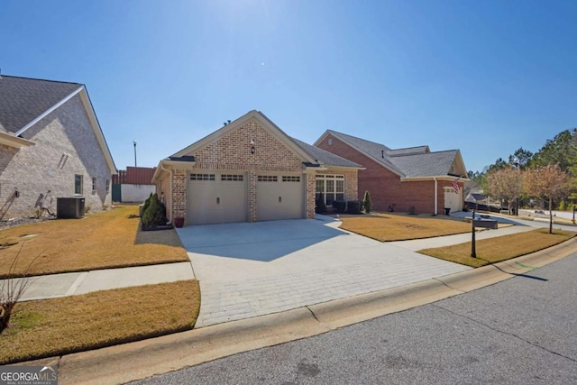 view of front of home with central air condition unit, driveway, a front yard, an attached garage, and brick siding