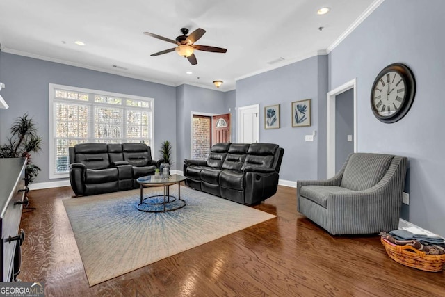 living area featuring baseboards, crown molding, ceiling fan, and wood finished floors