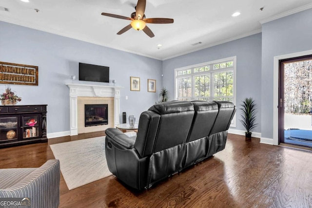 living area with a healthy amount of sunlight, baseboards, and a ceiling fan