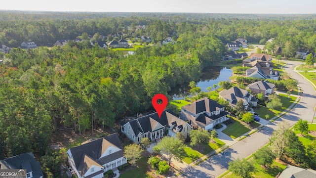 birds eye view of property featuring a residential view and a view of trees