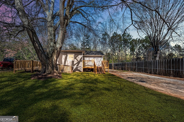 view of yard with fence and a wooden deck