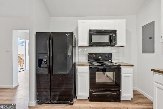 kitchen featuring electric panel, black appliances, white cabinets, light wood-style floors, and backsplash