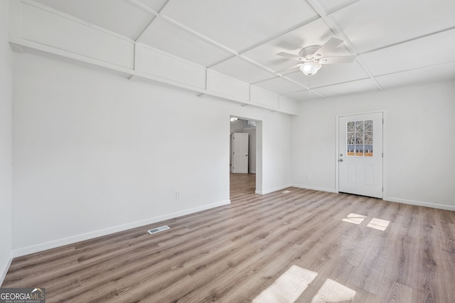 empty room with visible vents, ceiling fan, baseboards, wood finished floors, and coffered ceiling