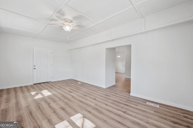 unfurnished room with light wood-type flooring, baseboards, visible vents, and ceiling fan