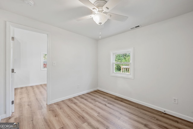 empty room with visible vents, baseboards, and light wood-style floors