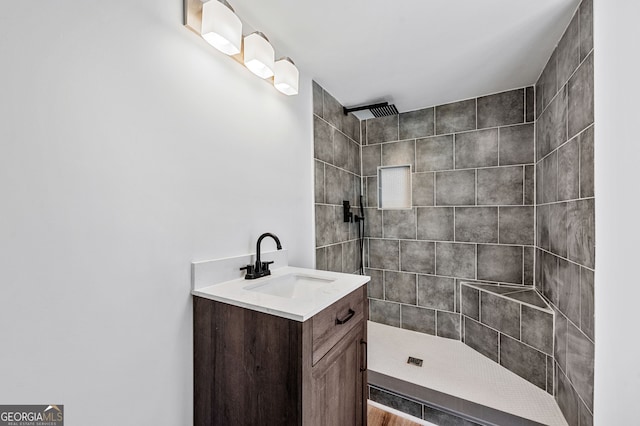 full bath with vanity and a tile shower