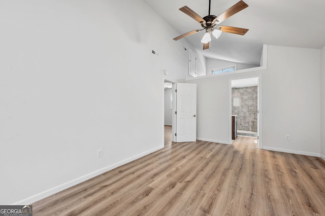 interior space with wood finished floors, visible vents, baseboards, high vaulted ceiling, and ceiling fan